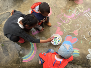 Kids Playing with Sidewalk Chalk