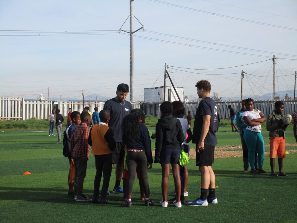 ACE in South Africa Group Prepare to Play Rugby on Field with Kids