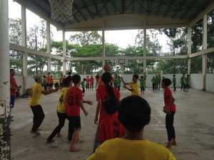 Children and Coaches Playing a Game of March Madness