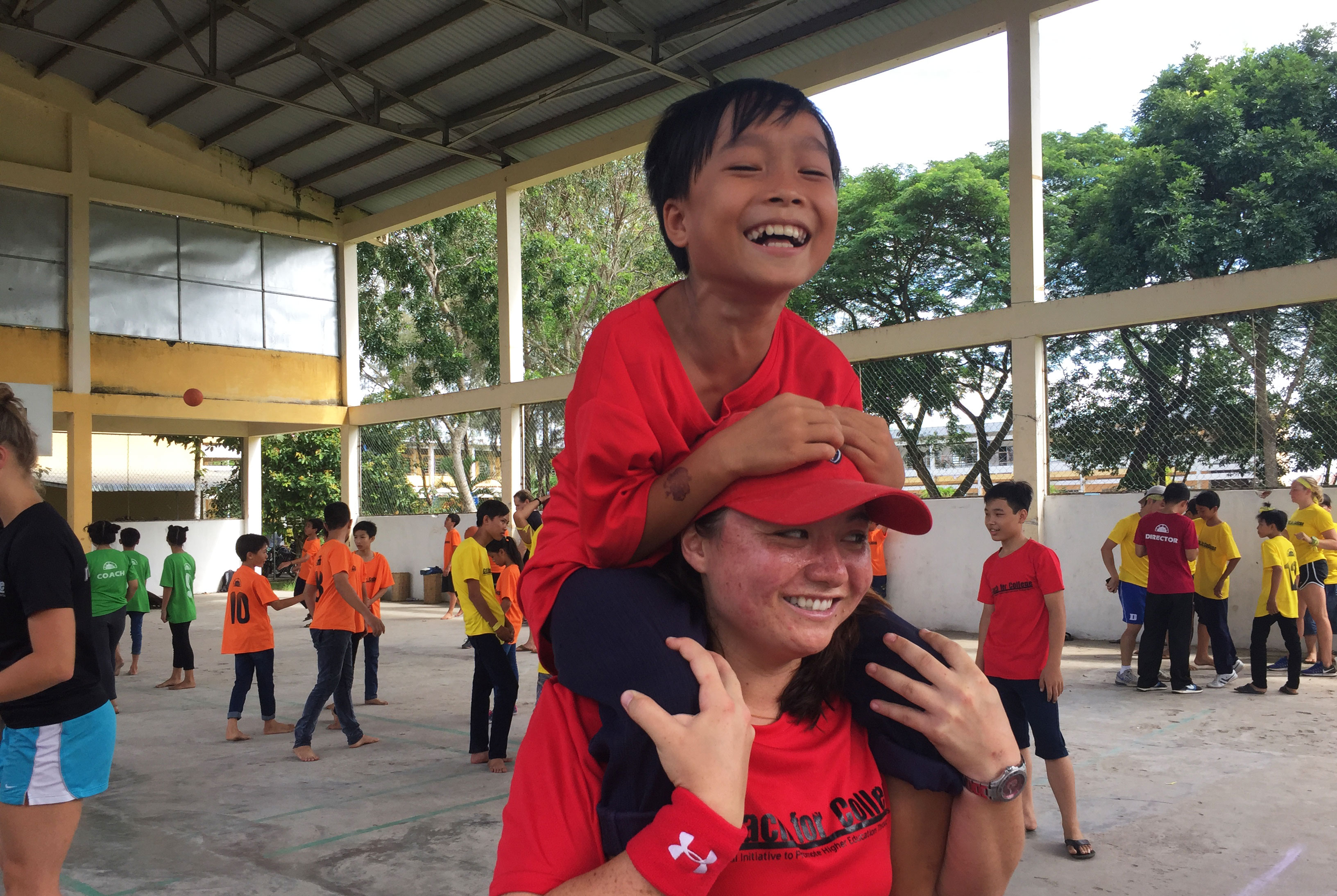 ACE Student-Athlete Giving Camper Piggyback Ride