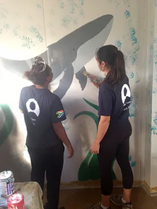 ACE Student-Athletes Painting Seal Mural