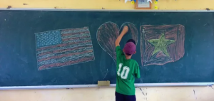 Student Writing on Chalkboard