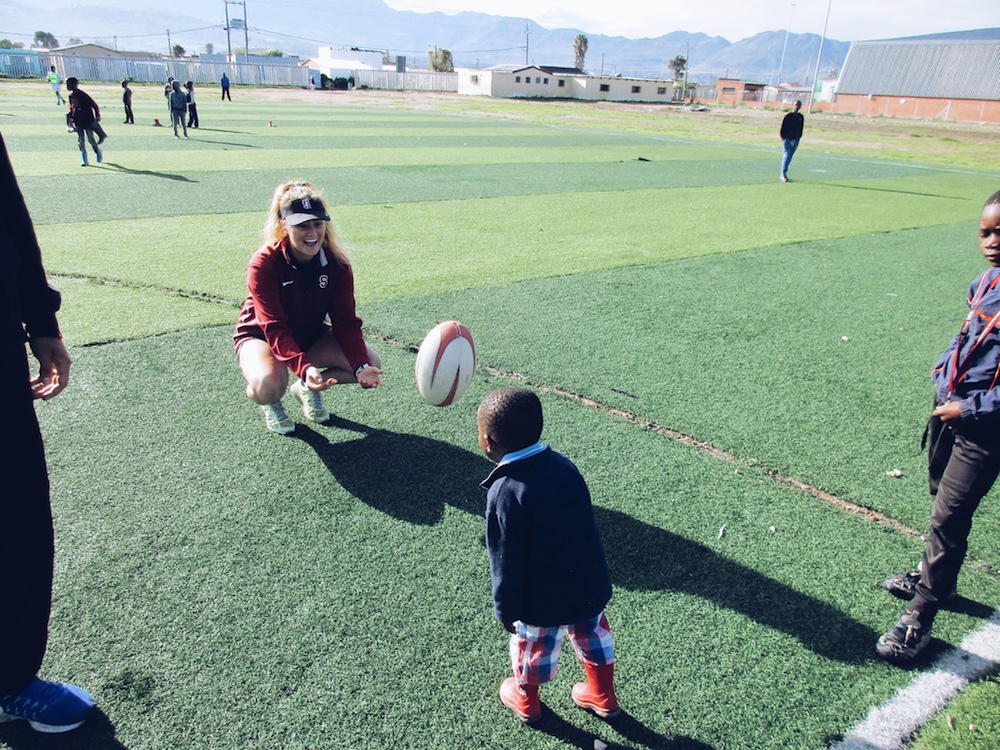 Logan Playing Rugby with Children Outside