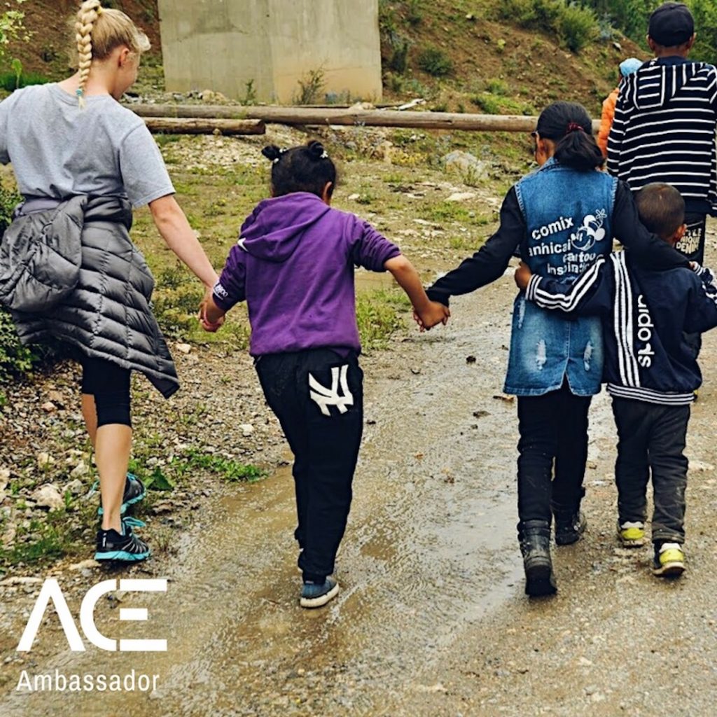 ACE participant holding hands with kids