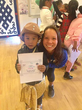 ACE Athlete smiling with one of her young campers