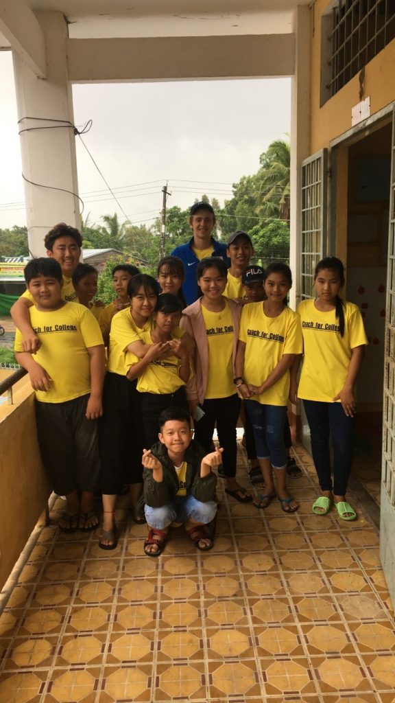 Duke student with Vietnamese students in yellow t-shirts