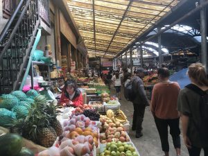 indoor market with stands of fruits and vegetables 