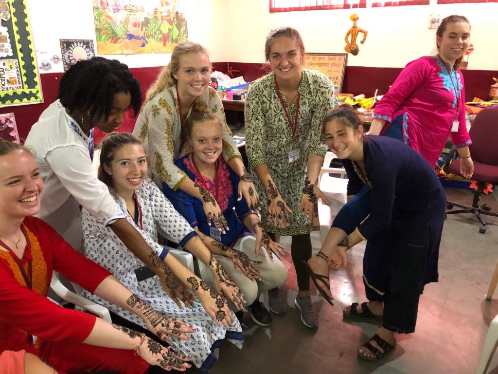 students showing henna on their arms