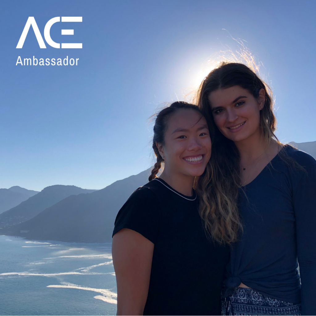 two women standing by mountainous overlook at dusk