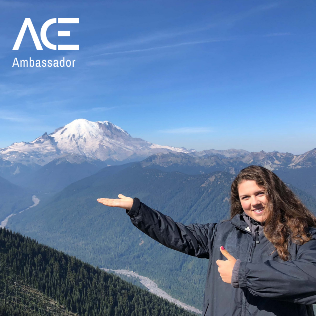 woman pointing to snowy mountain