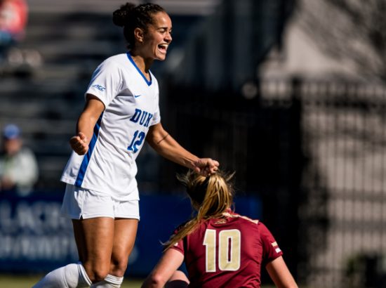 woman cheering and jumping on soccer field