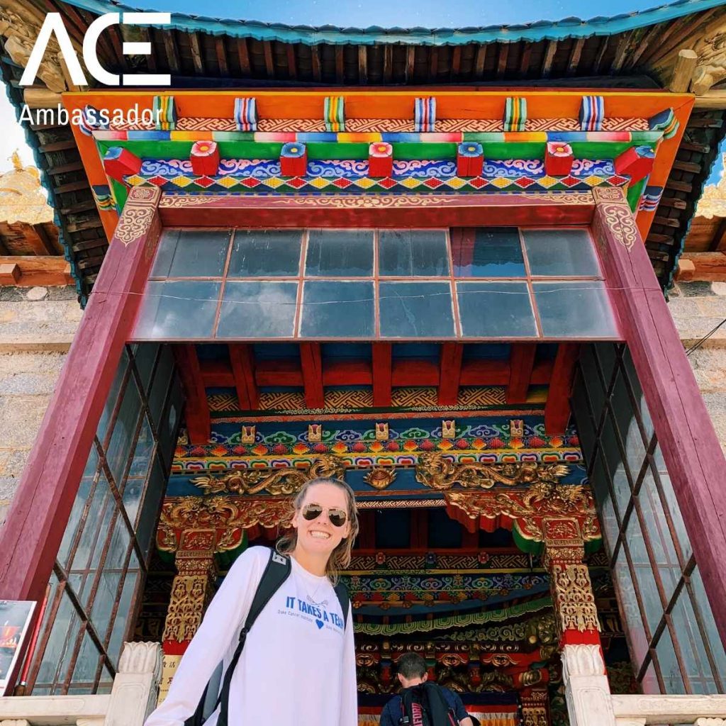 woman posing in front of colorful architecture
