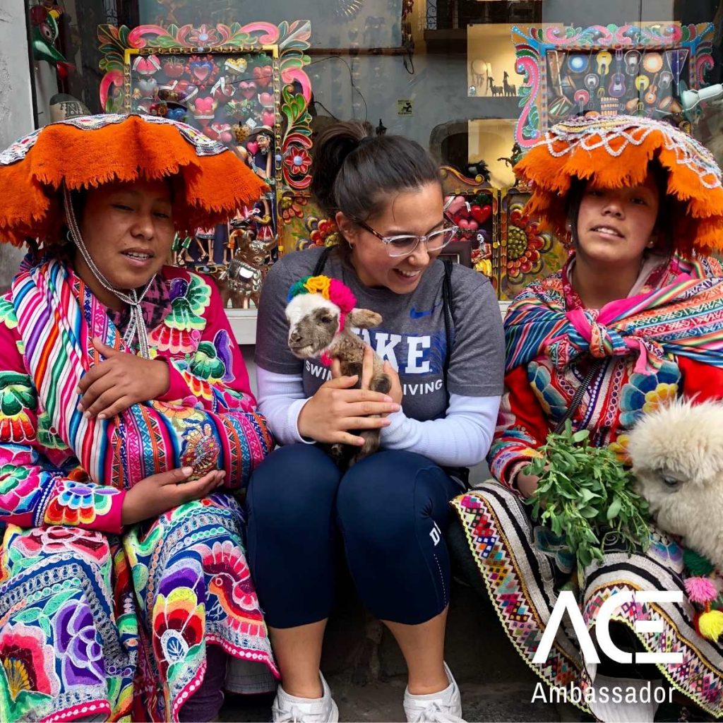 woman in between two colorfully dressed women