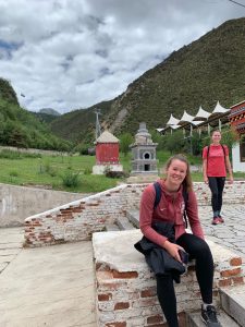 female sitting in front of mountains