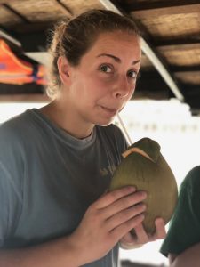 young adult female drinking coconut drink