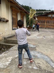 children playing with lacrosse sticks outside
