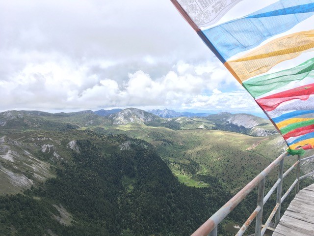 colorful prayer flag with mountain in the background