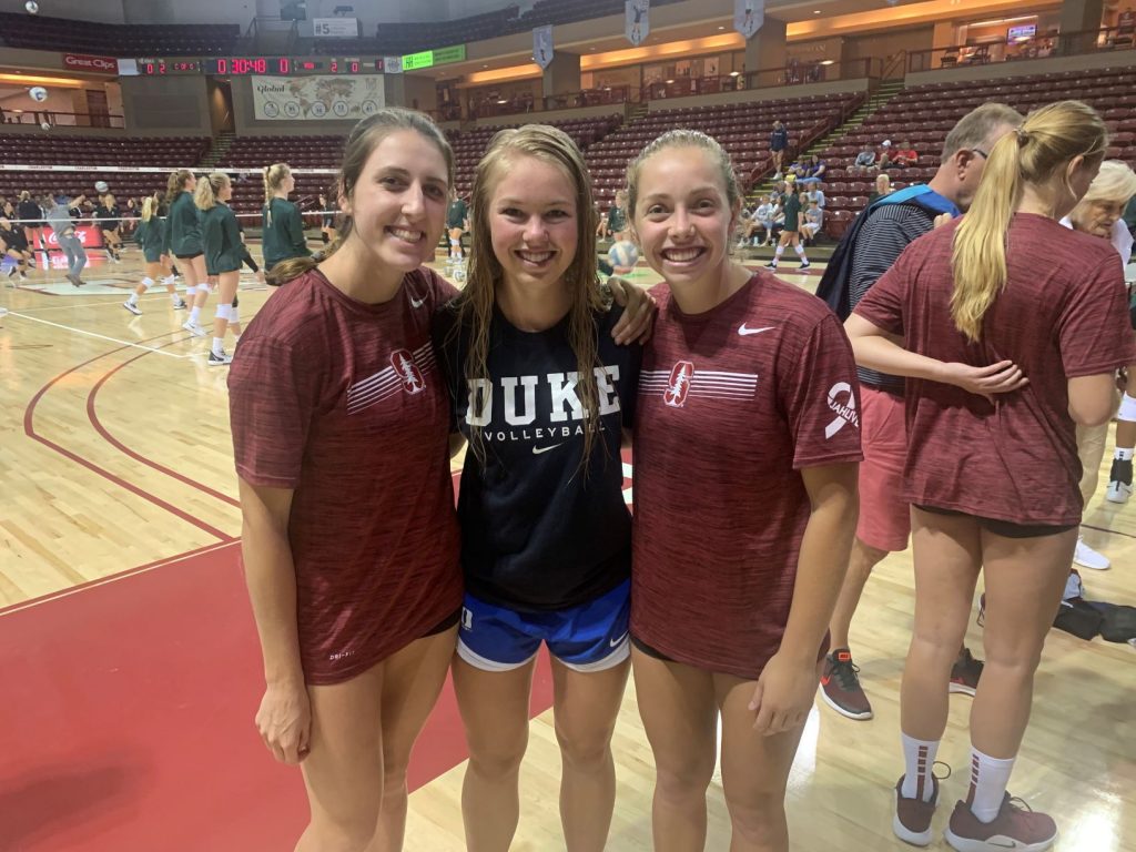 three women's volleyball players