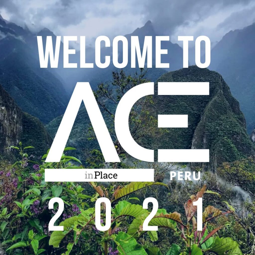 green mountainous overlook behind ACE in Place Peru welcome logo