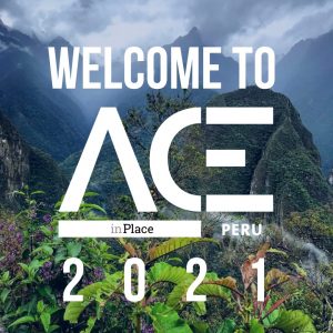 green mountainous overlook behind ACE in Place Peru welcome logo