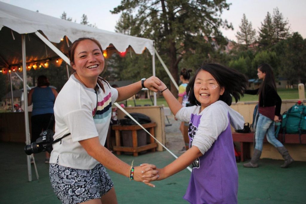 woman and student dancing outside