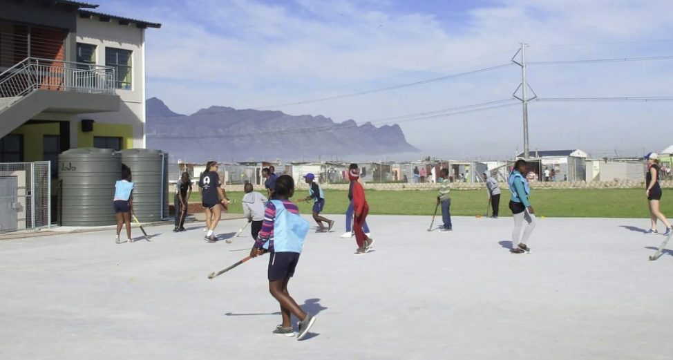students and teachers playing sports outside