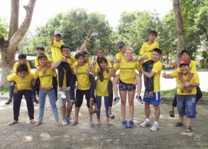 group of people in yellow t shirts smiling