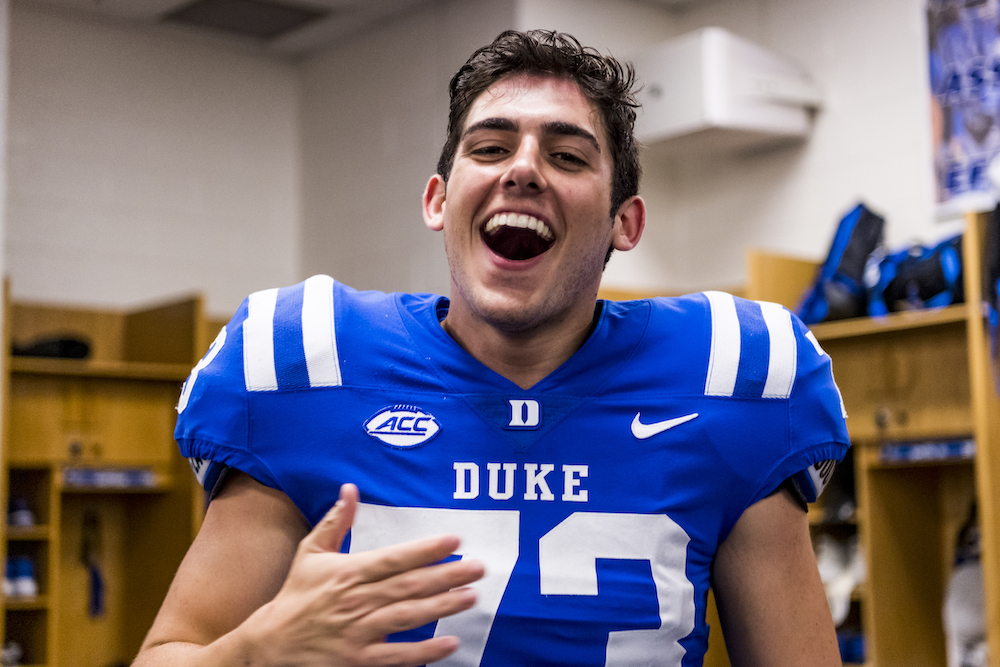 man in blue football uniform celebrating