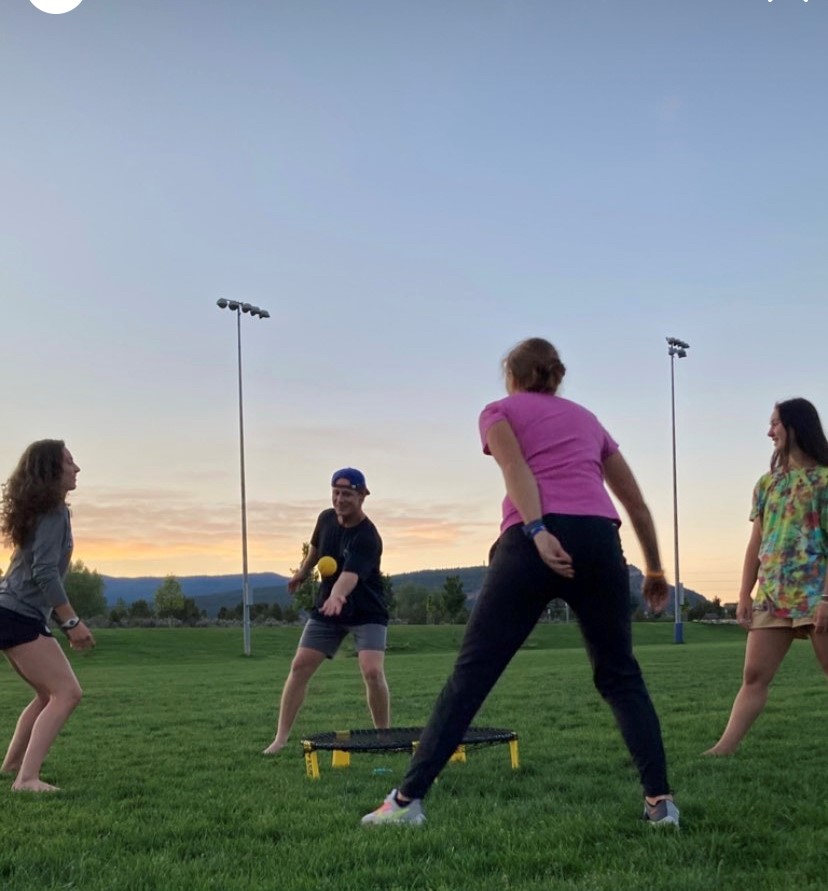 group playing spikeball at sunset