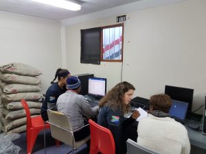 woman and man talking at computer