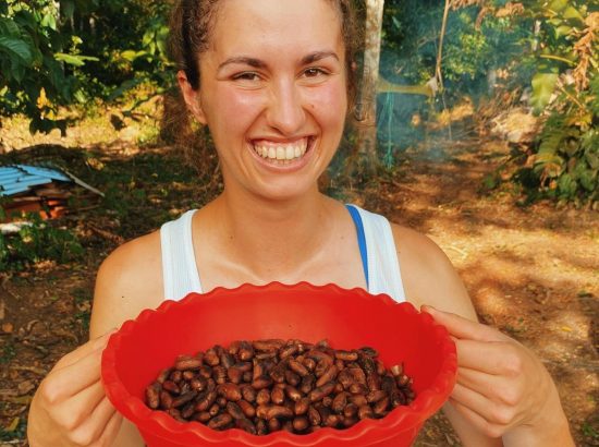 woman holding bowl of coffee beans