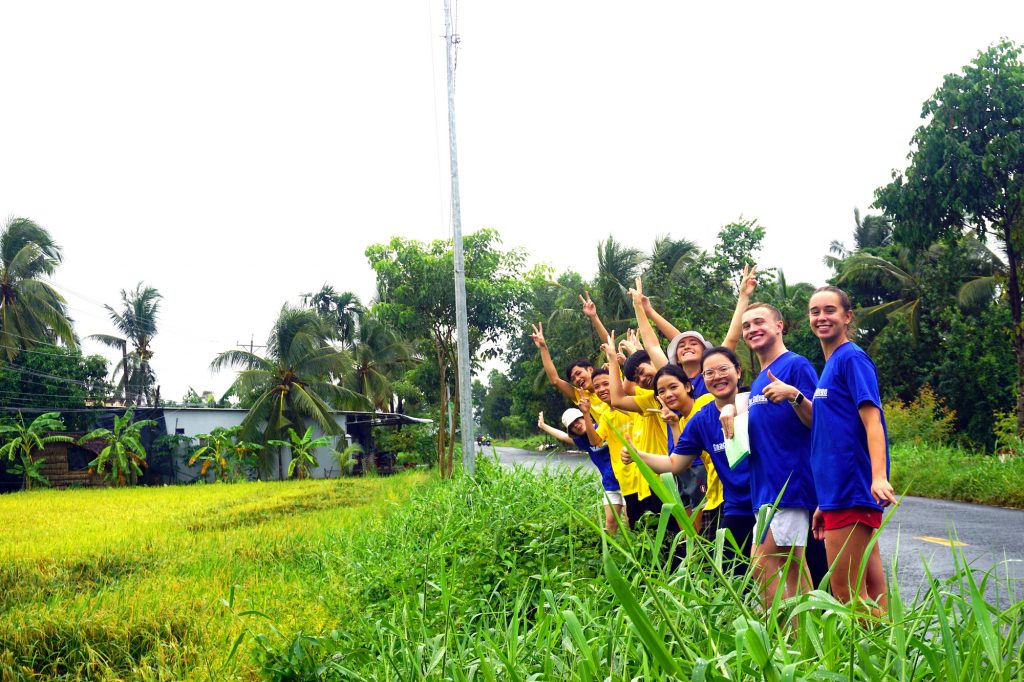 group of people smiling in field