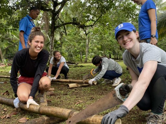 two students engaging in sustainable farming practices