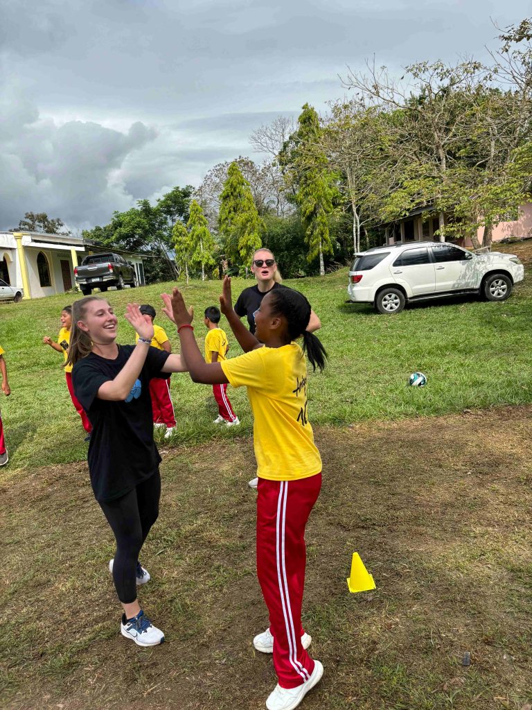 two girls high fiving