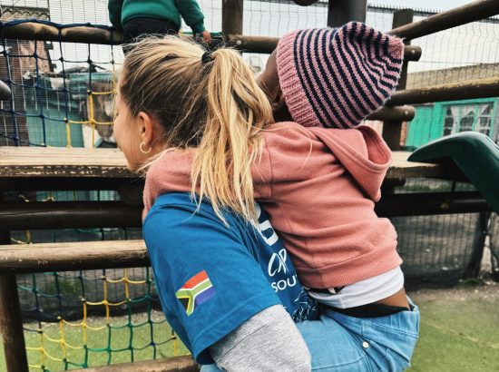 student giving a piggyback ride to a child