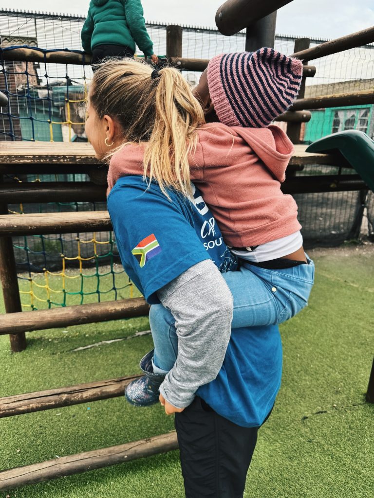 student giving a piggyback ride to a child