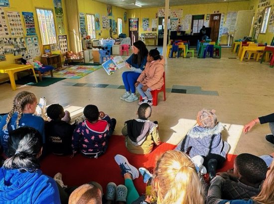 Student reading to children