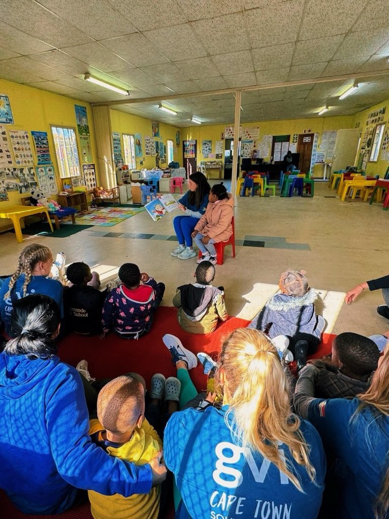 Student reading to children