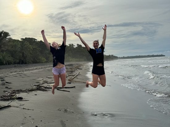 students jumping on beach in Costa Rica