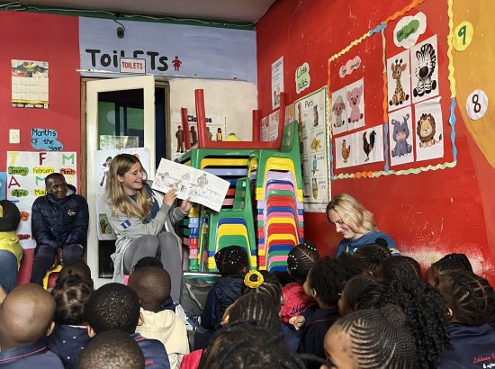 student reading to a group of kids