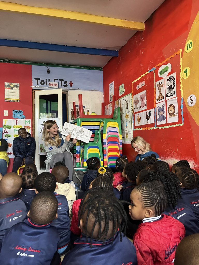 student reading to a group of kids