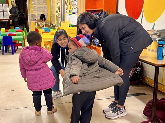 two students with children