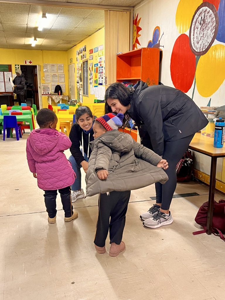 two students with children