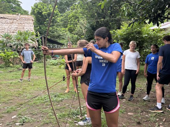 student with bow and arrow