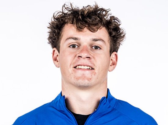 headshot wearing blue quarter zip