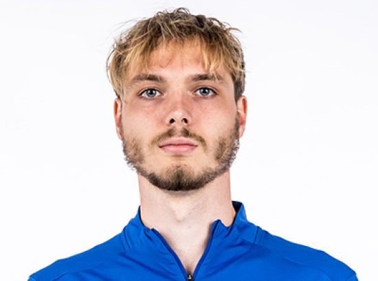 headshot in blue quarter zip
