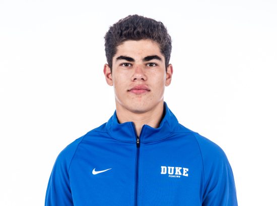headshot in blue zip up