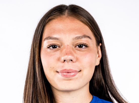 headshot in blue polo